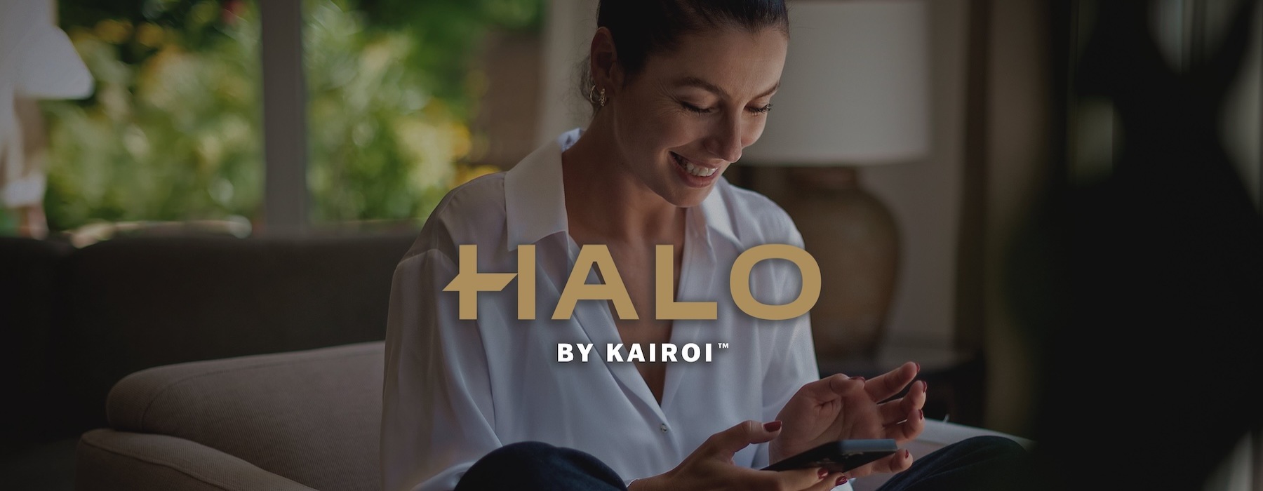 a woman smiling and interacting with her device